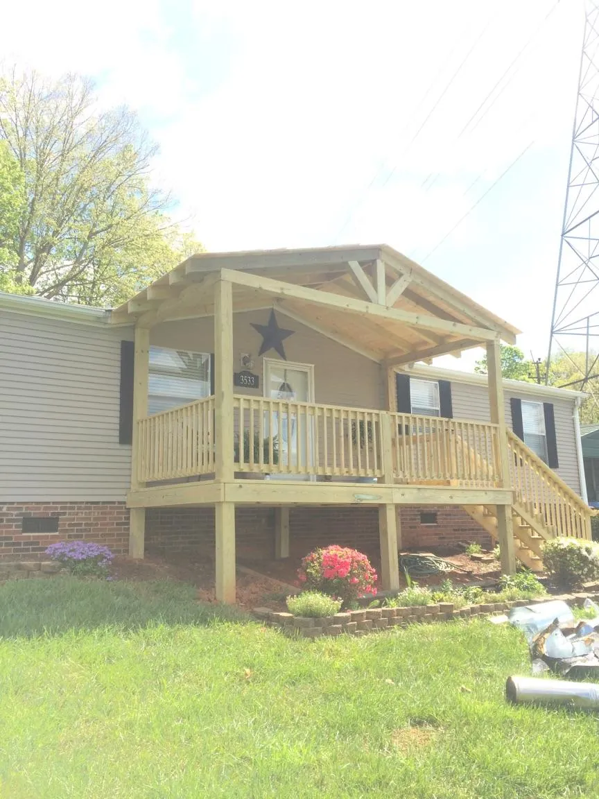 New gabled porch roof and deck railing added to a ranch home in Westlake